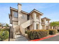 Inviting condo exterior featuring well-maintained landscaping and staircase leading to upper units at 9901 Trailwood Dr # 2144, Las Vegas, NV 89134
