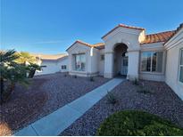 Charming single-story home with desert landscaping, a red tile roof, and an arched entrance at 9937 Villa Ridge Dr, Las Vegas, NV 89134