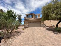 Charming two-story home with a brick driveway and a well-maintained front yard at 2773 Drumlanrig St, Henderson, NV 89044
