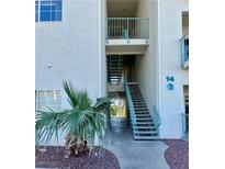 Exterior view of unit 14 featuring stairwell and desert landscaping at 3550 Bay Sands Dr # 2097, Laughlin, NV 89029
