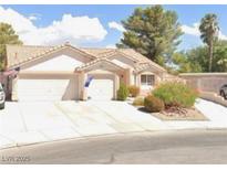 Charming single-story home with a tile roof, two-car garage, and well-maintained front yard landscaping at 4600 Windy Hollow St, Las Vegas, NV 89130