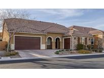 Charming single-story home featuring a tile roof, two-car garage, and tasteful desert landscaping at 6021 Vista Clara St, Las Vegas, NV 89148