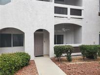 Inviting condo exterior with landscaped garden and private entrance and covered balcony with ceiling fan at 700 Carnegie St # 2013, Henderson, NV 89052