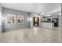 Bright, spacious living room with tile floors and sliding door to backyard at 7660 W Eldorado Ln # 128, Las Vegas, NV 89113