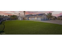 Charming single-story home with well-manicured lawn and solar panels offers sustainable living at 8515 Belcastro St, Las Vegas, NV 89113