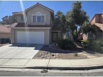 Charming two-story home features a two-car garage and well-maintained landscaping at 8771 Martinique Bay Ln, Las Vegas, NV 89147