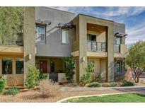 Beautiful three-story townhouse featuring modern architectural design and desert landscaping at 1541 Unison Way # 102, Las Vegas, NV 89135