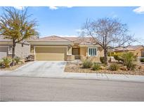 Charming single-story home with a two-car garage and desert landscaping at 2104 Willow Wren Dr, North Las Vegas, NV 89084