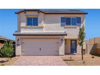 Charming two-story home featuring a spacious two-car garage and a well-manicured front yard, perfect for Gathering living at 2606 Lily Point St, Las Vegas, NV 89156