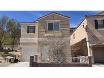 Charming two-story home features a front fence, and a well-manicured lawn at 3457 Abilene Gold Ct, Las Vegas, NV 89129