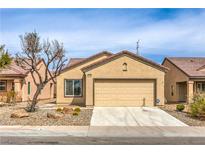 Charming single-story home featuring desert landscaping, a two-car garage, and a neutral color scheme at 3520 Kittiwake Rd, North Las Vegas, NV 89084
