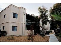 Two-story apartment building with a red tiled roof, side stairs, and desert landscaping at 5158 S Jones Blvd # 107, Las Vegas, NV 89118