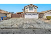 Inviting two-story home showcasing a wide driveway and a secure, decorative gate for added privacy at 5364 Awbury Ave, Las Vegas, NV 89110