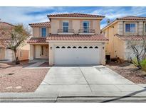 Inviting two-story home boasts a tile roof, desert landscaping, and a spacious two car garage at 7582 Tuckaway Harbor St, Las Vegas, NV 89139