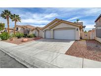 Charming single-story home featuring a three-car garage and desert landscaping at 8301 Shad Bush Ave, Las Vegas, NV 89149