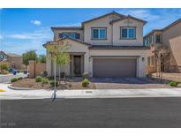 Two-story home featuring a neutral color scheme, a two-car garage, and low maintenance landscaping at 10367 Andele Ave, Las Vegas, NV 89166