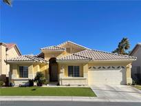 Charming single-story home featuring a tile roof, manicured lawn, and attached two-car garage at 4532 Laguna Vista St, Las Vegas, NV 89147
