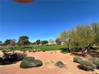 Views of the adjacent golf course are available from this homesite in this desirable community at 5000 Burr Oak Dr, Las Vegas, NV 89130