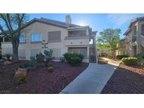 Attractive condominium featuring well-maintained landscaping and a welcoming walkway leading to the entrance at 5710 E Tropicana Ave # 2049, Las Vegas, NV 89122