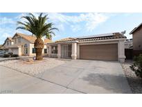 Charming single-story home with desert landscaping, tile roof, and two-car garage at 715 Rusty Spur Dr, Henderson, NV 89014