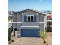 Charming two-story home with blue garage door, shutters, and brick driveway at 7449 Bosco Dr # Lot 106, North Las Vegas, NV 89084