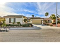 Charming single-story home featuring a two-car garage and well-manicured landscaping with palm trees at 2229 Suffron Hills Ct, Henderson, NV 89044