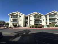 Three-story condo building with balconies and well-maintained landscaping at 3550 Bay Sands Dr # 3044, Laughlin, NV 89029