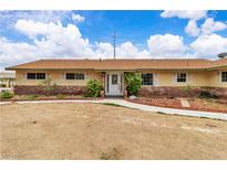 Charming single-story home featuring a well-maintained lawn and inviting entryway at 4678 Saddle Pl, Las Vegas, NV 89119