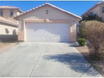 Charming single-story home with a well-maintained front yard and a two-car garage at 5404 Walcott Dr, Las Vegas, NV 89118