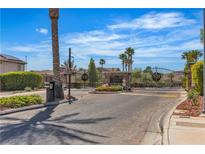 A gated entry welcomes residents to the Stetson Ranch community, featuring lush landscaping and a secure entrance at 6148 Whitelion Walk St, Las Vegas, NV 89148