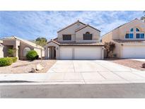 Two-story home featuring a two-car garage, neutral stucco, and low-maintenance desert landscaping at 80 Sea Holly Way, Henderson, NV 89074
