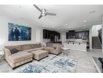 Spacious living room featuring an open floorplan, stylish decor, and modern ceiling fan at 1015 Solana Crest St, Henderson, NV 89052