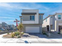 Contemporary two-story home featuring a brick driveway and a neutral-colored exterior, situated in a modern neighborhood at 10165 Canyon Mantle St, Las Vegas, NV 89166