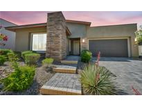 Charming single story home with a stone accent wall, three steps to the front door, and a two car garage at 10348 Bressana Dr, Las Vegas, NV 89135