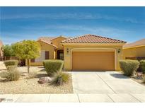 Charming single-story home featuring a tile roof, a two-car garage and well-manicured landscaping at 1074 Wagon Trl, Mesquite, NV 89034