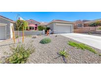 Charming single-story home featuring a low-maintenance gravel yard and a two-car garage at 2734 Grand Forks Rd, Henderson, NV 89052