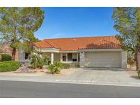 Charming single-story home featuring a red tile roof, desert landscaping, and an attached two-car garage at 2920 Crown Ridge Dr, Las Vegas, NV 89134