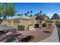 Charming single-story home with a two-car garage, desert landscaping, and a tiled roof at 364 Wild Plum Ln, Las Vegas, NV 89107