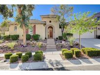 Charming single-story home featuring a landscaped front yard with stone accents and a welcoming arched entryway at 3663 Coventry Gardens Dr, Las Vegas, NV 89135