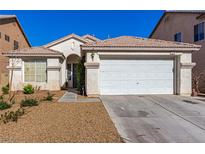 Charming single-story home features a two-car garage and desert landscaping for easy maintenance at 5046 Great Abaco St, North Las Vegas, NV 89031