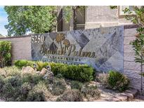 Attractive stone sign for Spanish Palms Condominiums surrounded by lush landscaping at 5250 S Rainbow Blvd # 2046, Las Vegas, NV 89118
