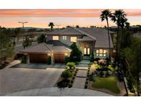 Stunning two-story home boasts a lush front yard, three-car garage, and vibrant sunset backdrop at 637 Edgebrook Dr, Las Vegas, NV 89145