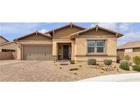 Charming single-story home with a two-car garage and desert landscaping at 665 Look Lively Ct, Henderson, NV 89011