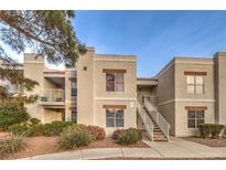 Inviting two-story condo with neutral stucco exterior, manicured landscaping, and stairway access to upper units at 6800 E Lake Mead Blvd # 1047, Las Vegas, NV 89156