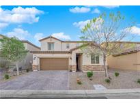 Charming two-story home with stone accents, a well-maintained yard, and a paved driveway at 1909 Pinsky Ln, North Las Vegas, NV 89032