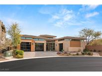 Contemporary desert home featuring desert landscaping, large windows and three car garage at 39 Cranberry Cove Ct, Las Vegas, NV 89135