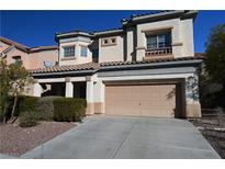 Two-story home featuring a two-car garage, desert landscaping, and a terracotta tiled roof at 6020 Genovese Ave, Las Vegas, NV 89141