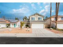 Charming two story home featuring a two car garage and desert landscaping at 9004 Crystal Glass Dr, Las Vegas, NV 89117