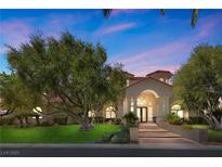 Charming single-story home with well-maintained landscaping and grand entrance with columns at 2101 Strada Mia Ct, Las Vegas, NV 89117