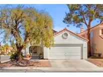 Charming single-story home with a well-maintained lawn, mature trees, and a two-car garage at 3016 Reef View St, Las Vegas, NV 89117